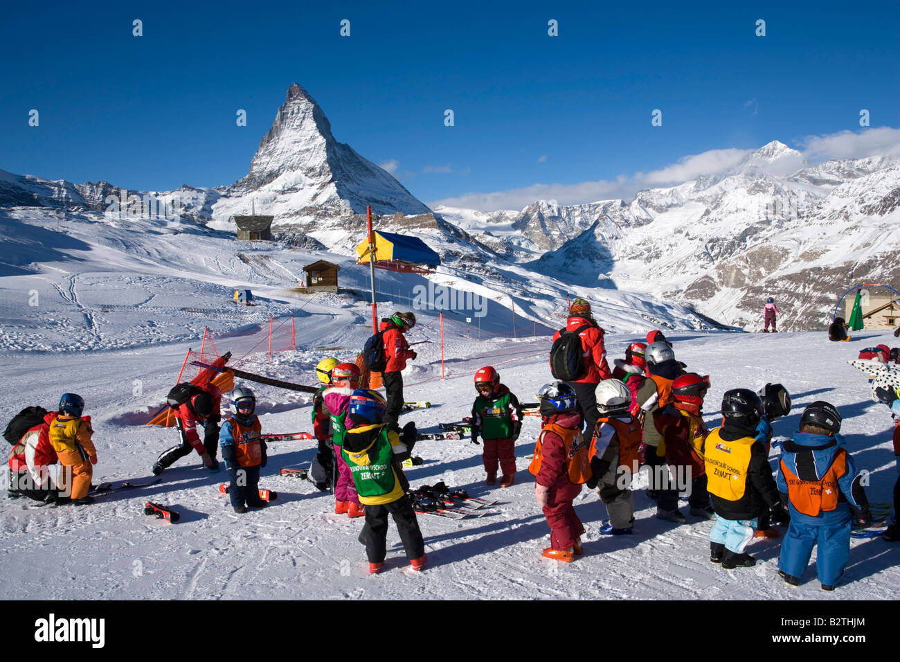 Children learning skiing, Matterhorn (4478 m) in background, Zermatt, Valais, Switzerland Stock Photo
