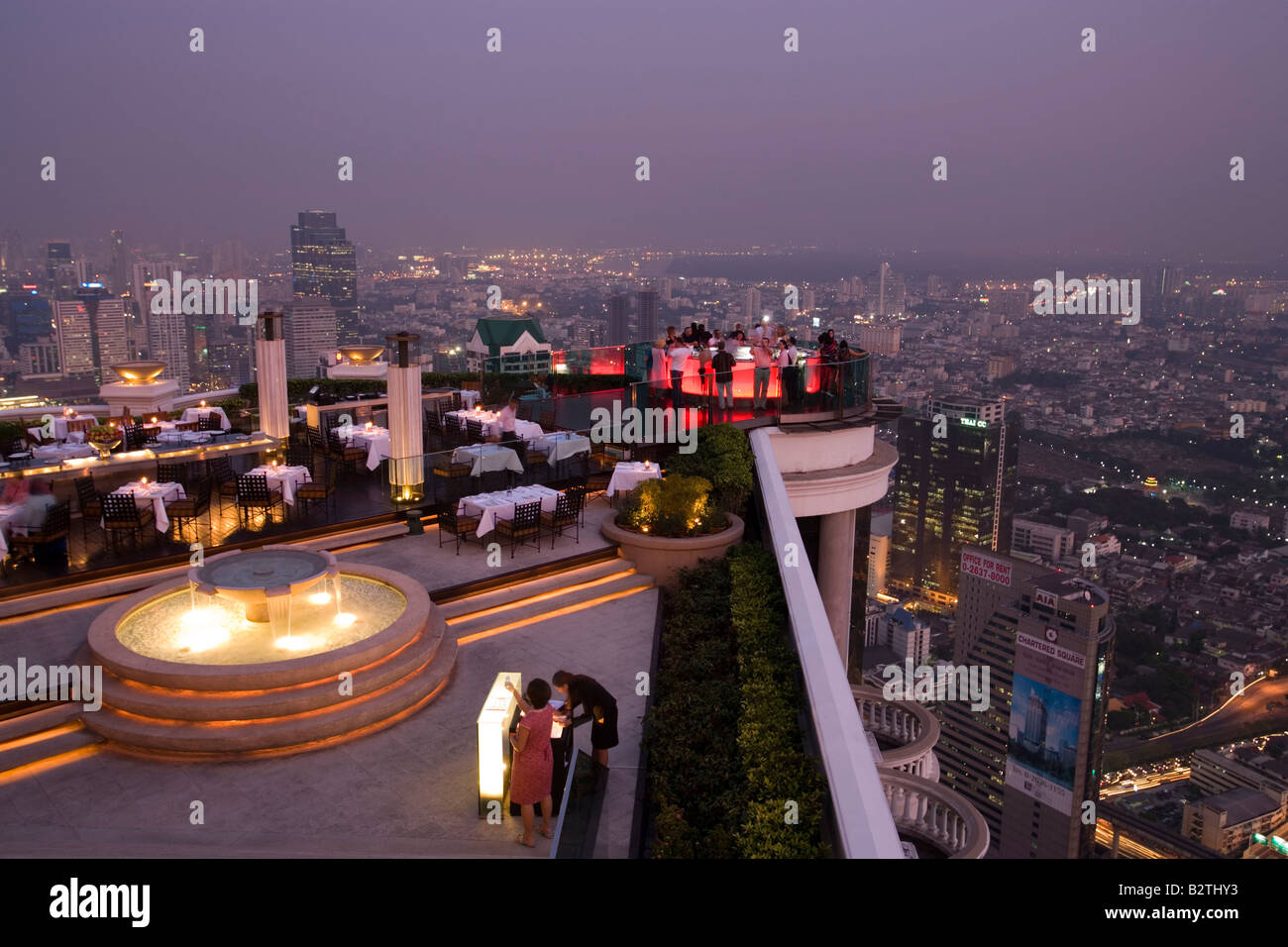 View over openair-bar 'Sirocco Sky Bar' and Bangkok in the evening, State Tower, 247 m, The Dome, Bangkok, Thailand Stock Photo