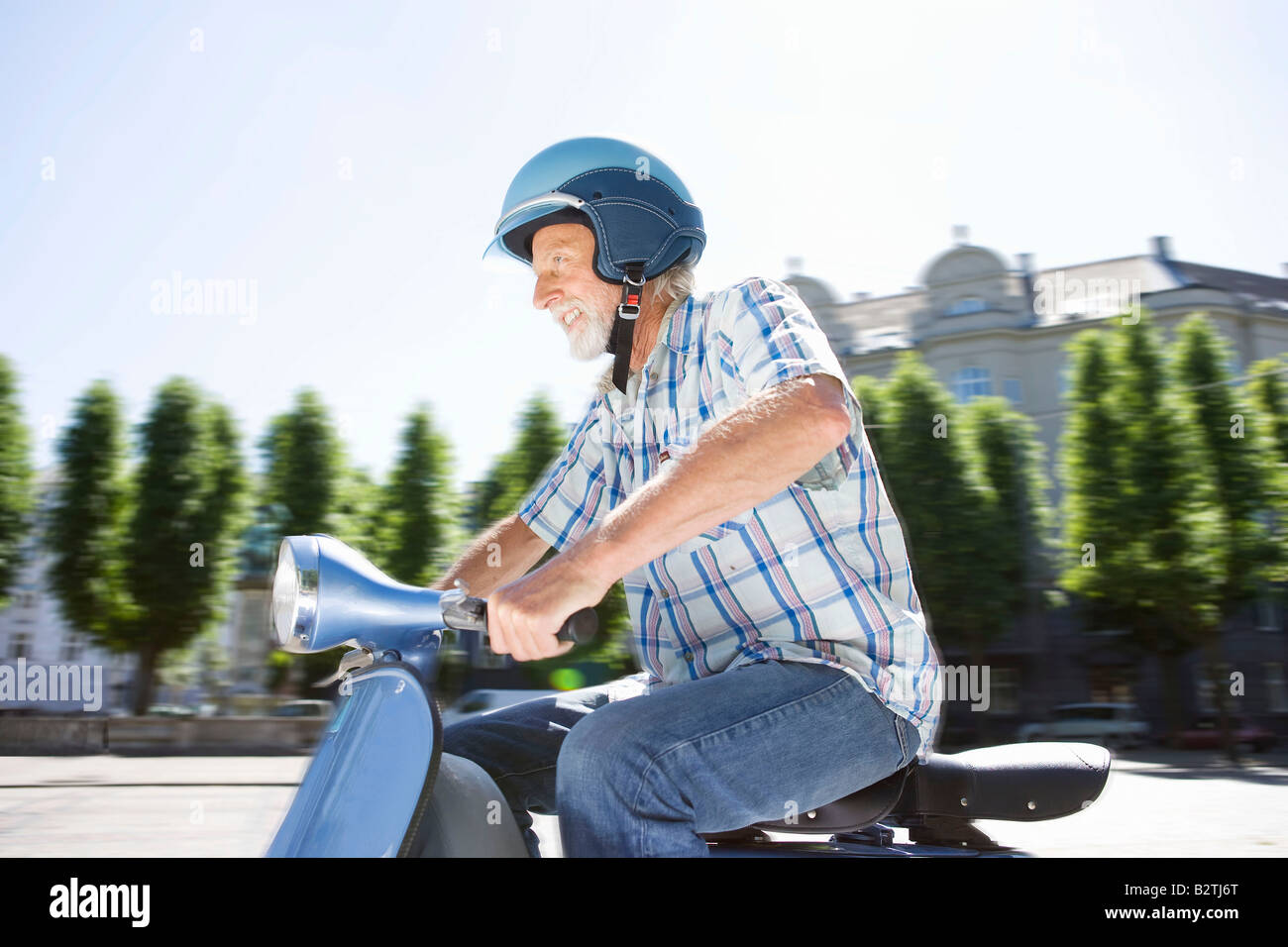 Man on scooter Stock Photo