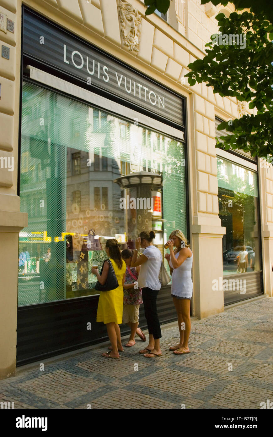 Group of tourist women in front of Louis Vuitton store on Parizska