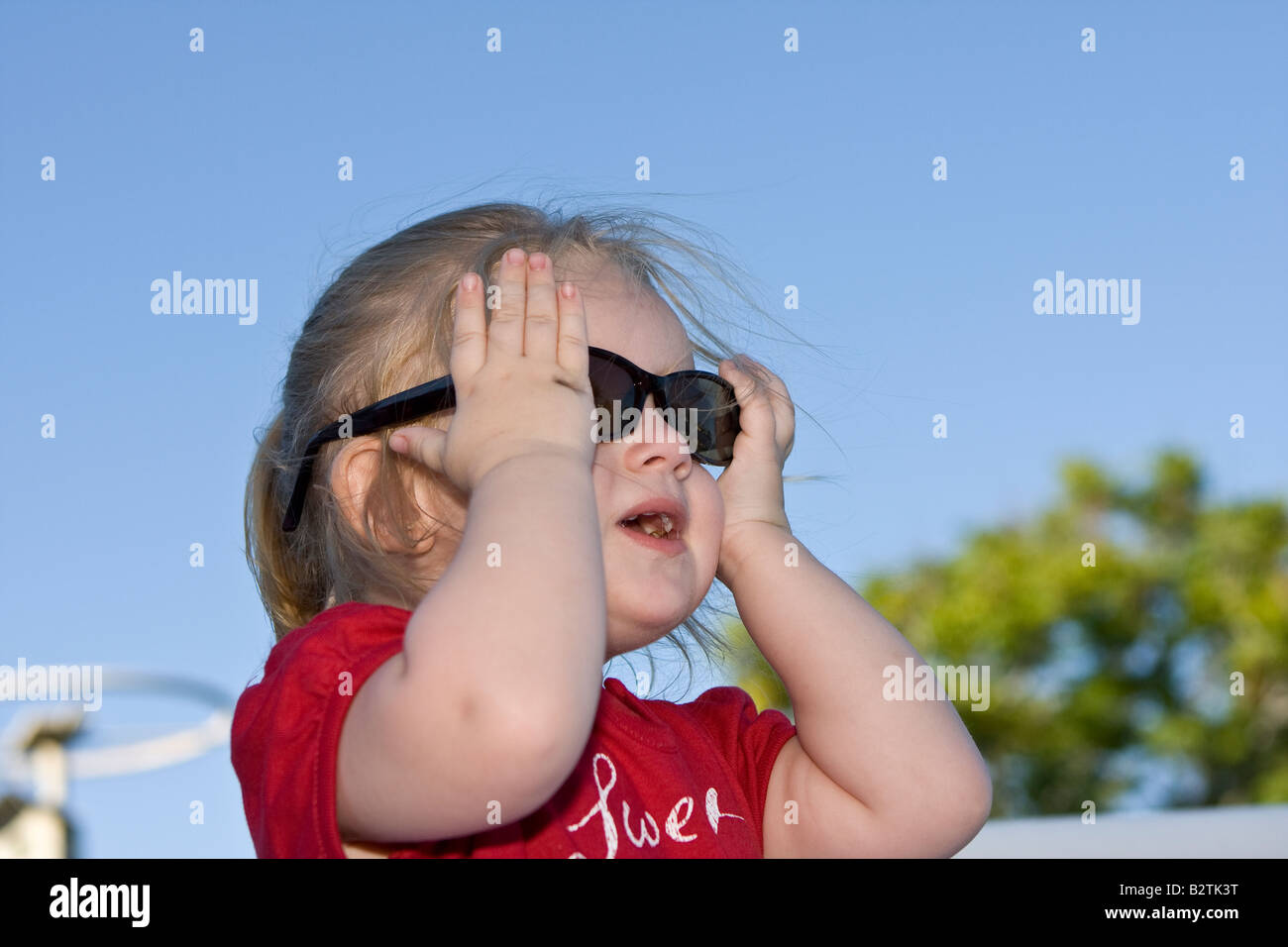 Female Toddler Model Wearing Large, Dark Sunglasses Stock Photo