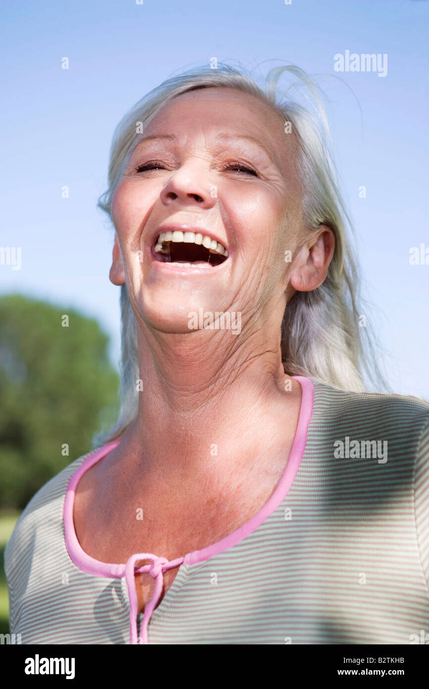 Mature woman portrait laughing Stock Photo - Alamy