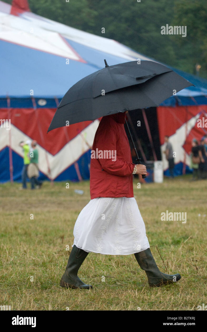 woman with umbrella in wellies Stock Photo