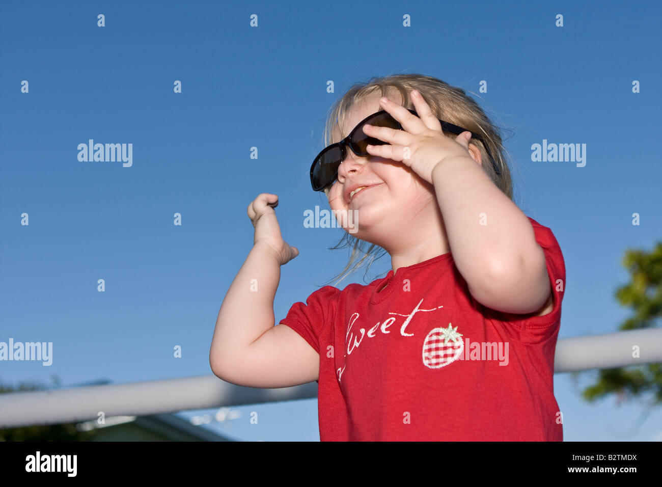 Female Toddler Model Wearing Large, Dark Sunglasses Stock Photo