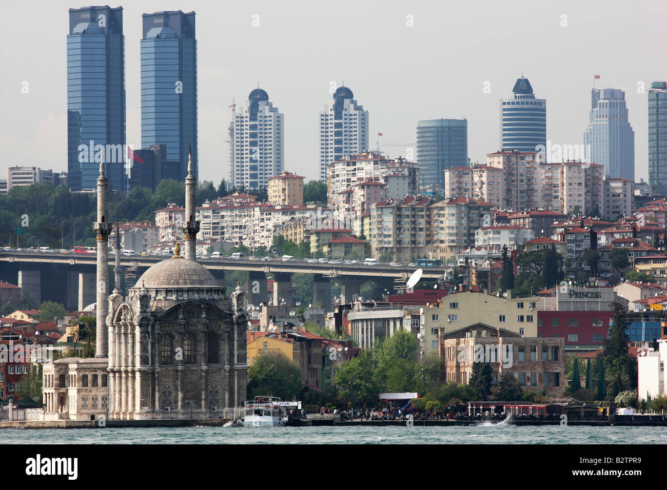 TUR Turkey Istanbul: Mecidiye mosque in the district of Ortaköy with the skyline of modern Istanbul Stock Photo