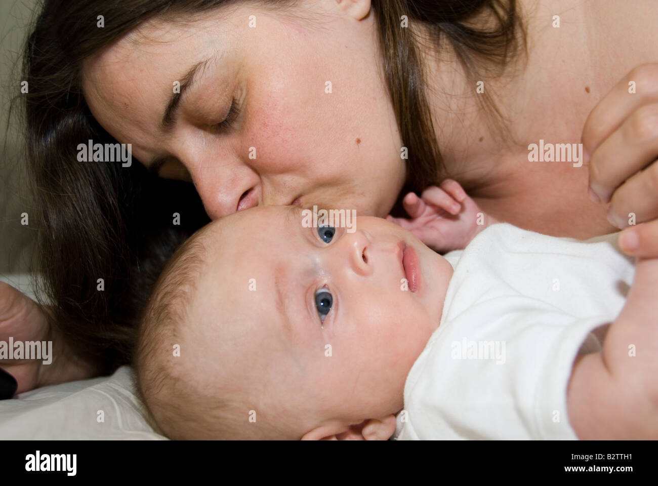 Baby Boy Joshua Kailas Hudson Aged 15 Weeks Being Kissed by Mother Deborah Waters Stock Photo