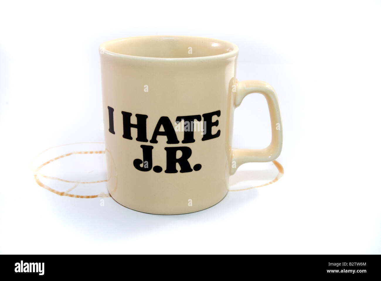 A cup of coffee with ring marks and the "I HATE JR" slogan. JR - the fictional evil boss character from the 80s TV series DALLAS Stock Photo