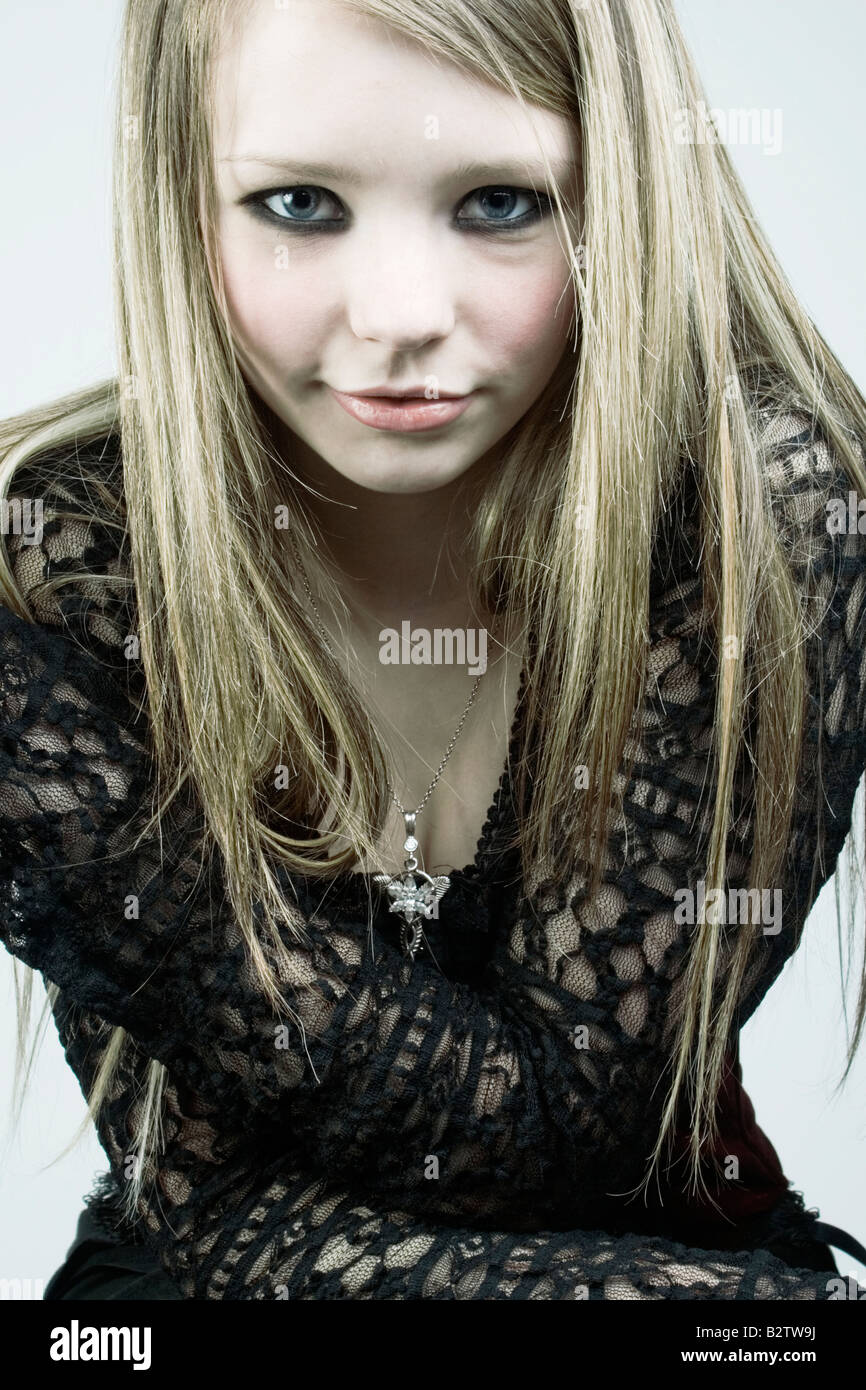 Portrit of a blonde teenager wearing a gothic style outfit. Stock Photo