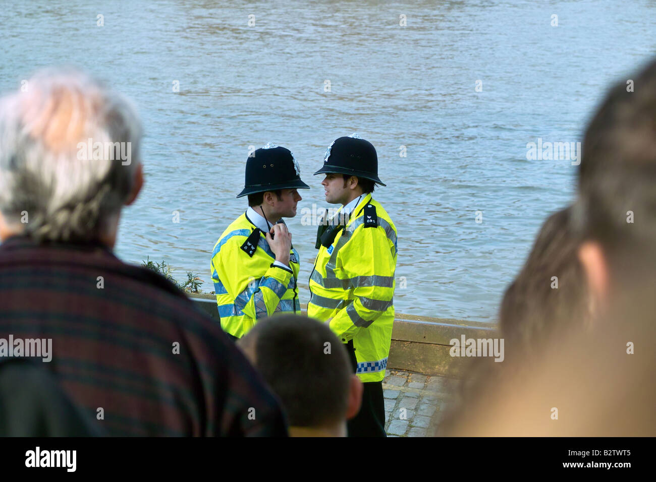 2 policemen facing each other on Thames bank Stock Photo