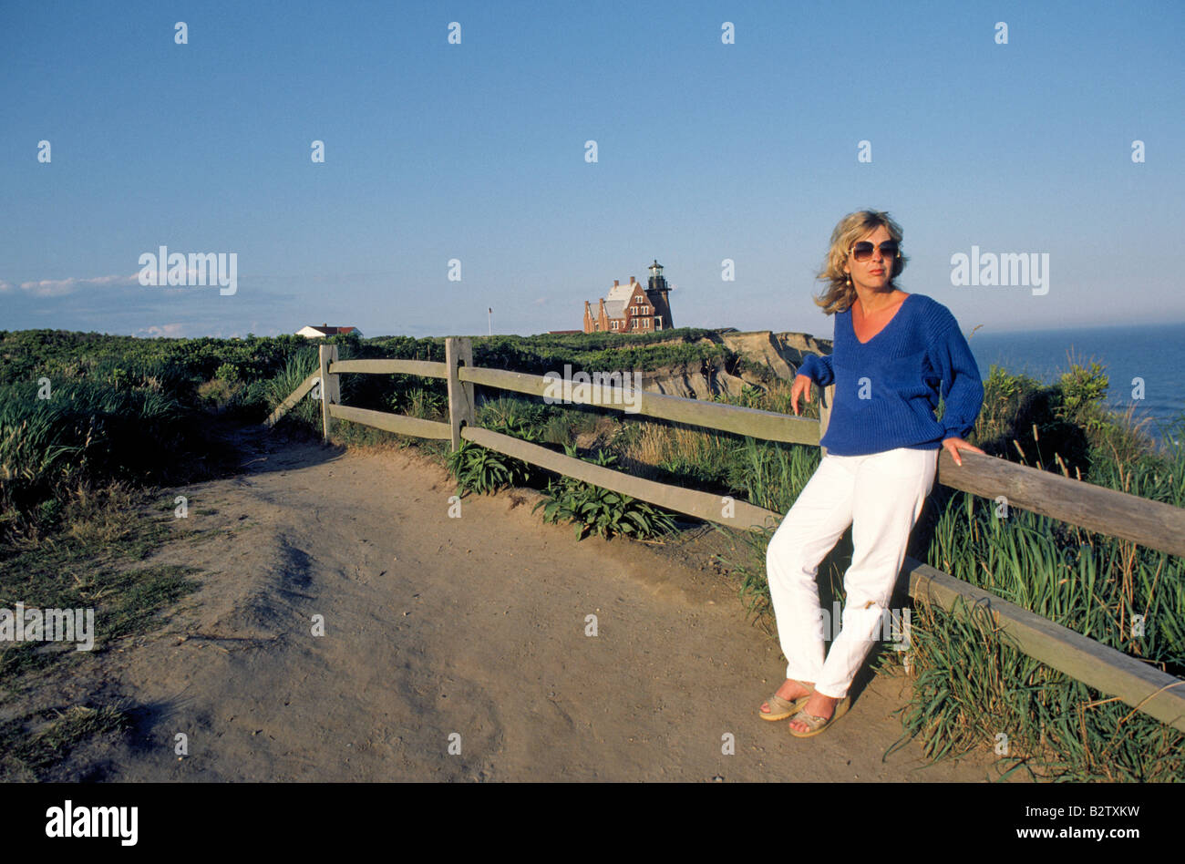 A hiker near the Block Island Lighthouse on the Atlantic Ocean Stock Photo