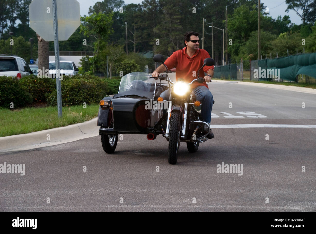 man riding a motorcycle with sidecar Gainesville Florida URAL YPAN motorcycle from Russia Stock Photo