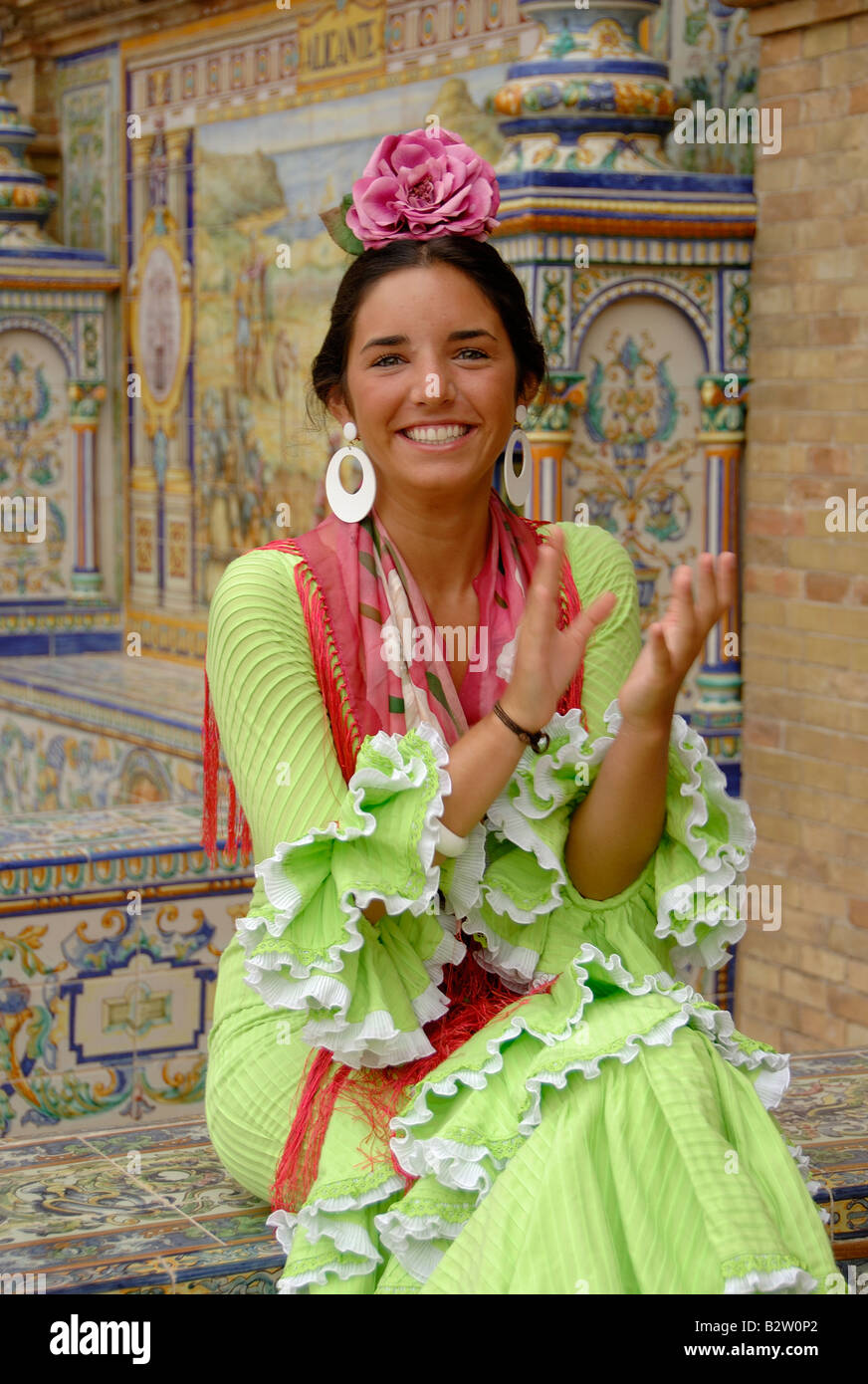 Seville fair Feria de Sevilla, young girl in traditional dress smiling and clapping Stock Photo