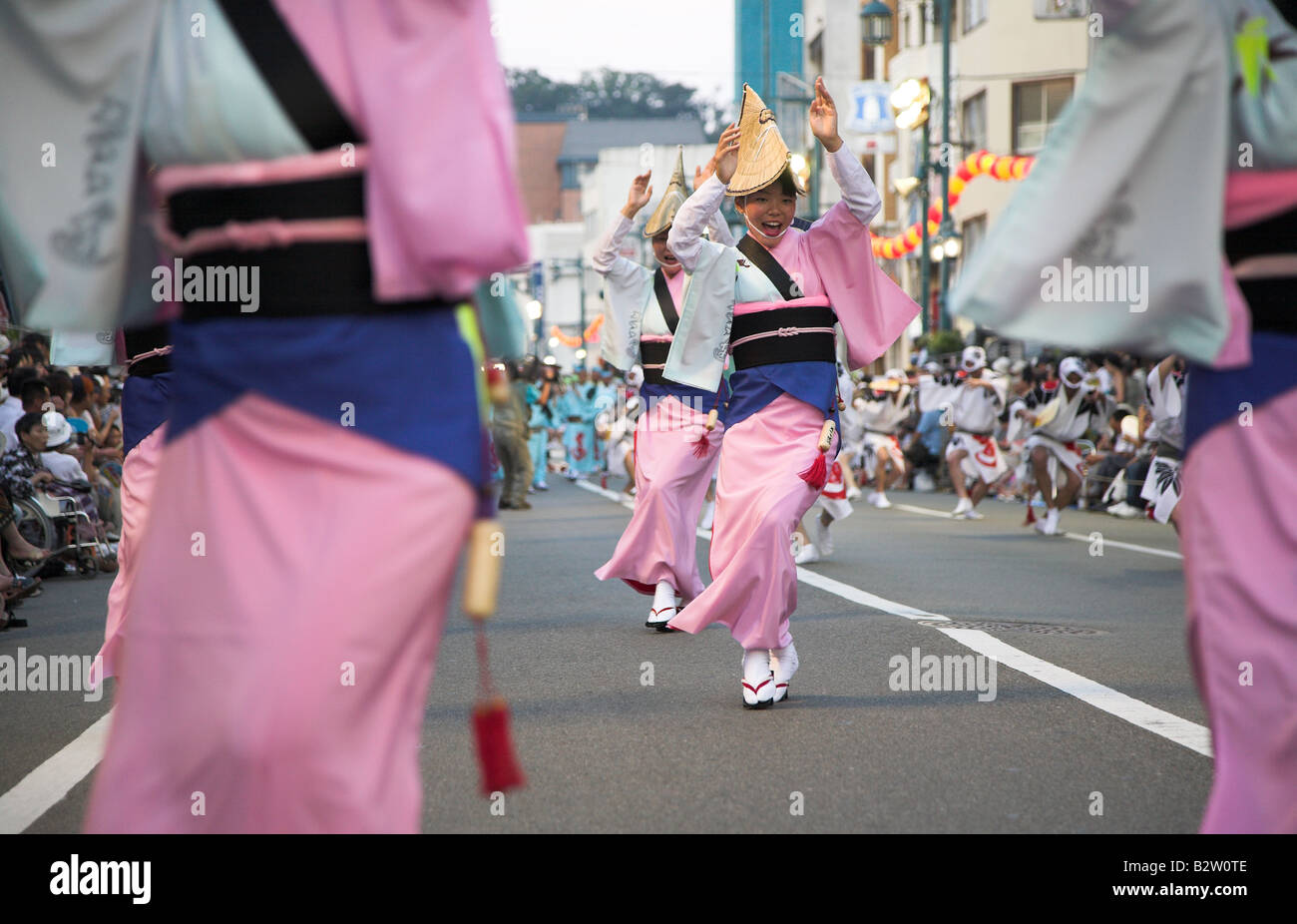 Dancers in tradtional japanese costume celebratng in the streets of