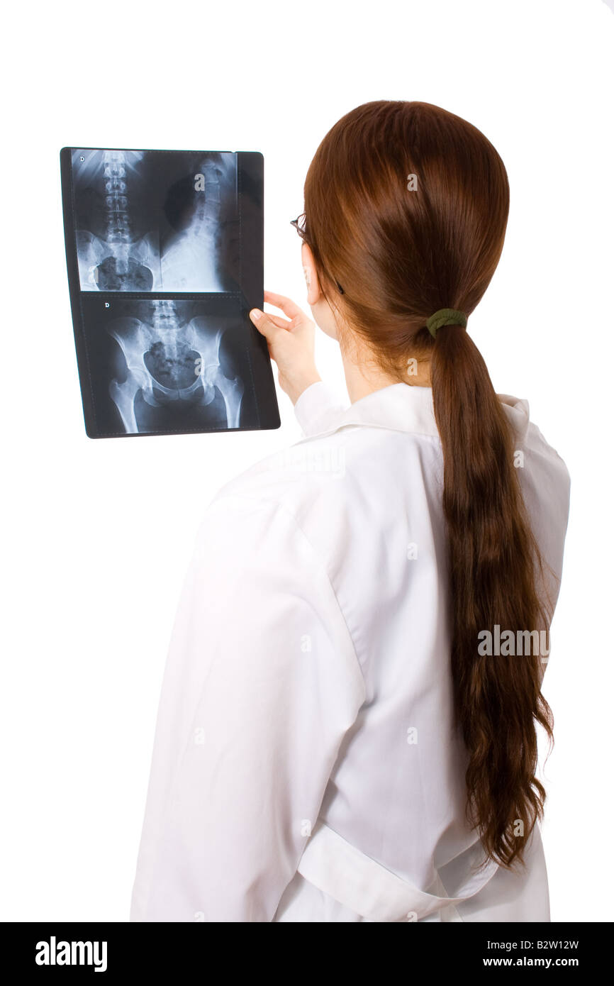 Female doctor examining a pelvis x-ray Stock Photo