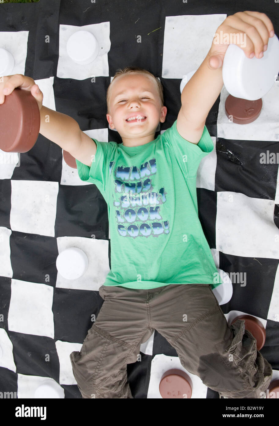 Boy on giant checkers board Stock Photo - Alamy