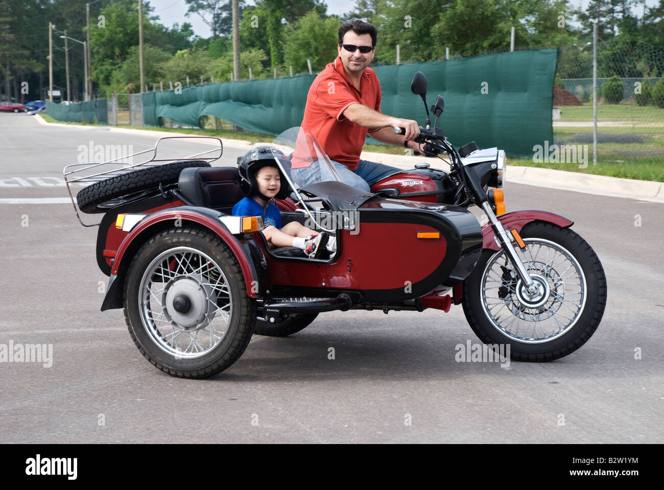 man on motorcycle with child in sidecar Gainesville Florida URAL YPAN motorcycle from Russia Stock Photo