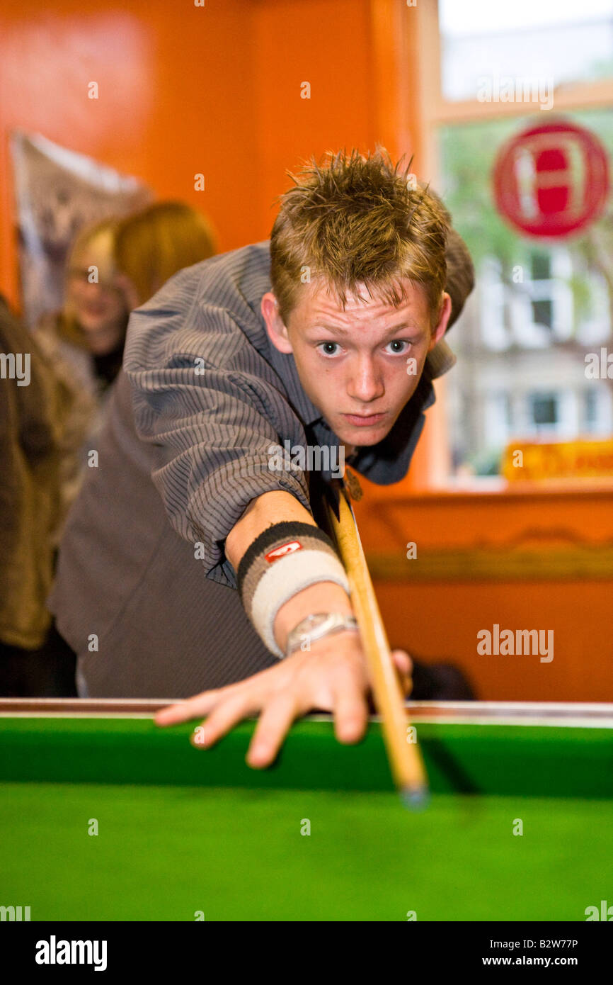 playing 8 ball pool in a youth centre Stock Photo