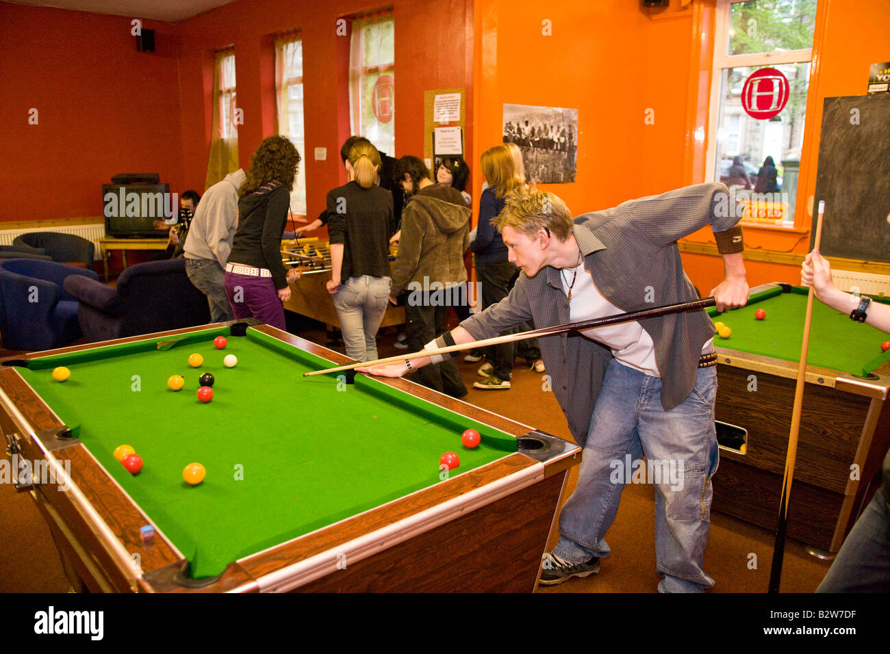 playing 8 ball pool in a youth centre Stock Photo