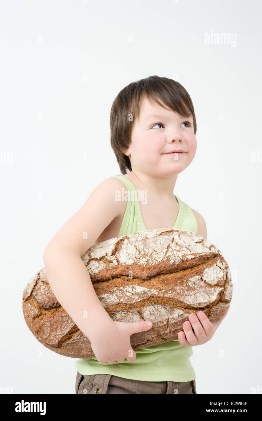 Boy holding loaf of bread Stock Photo Alamy