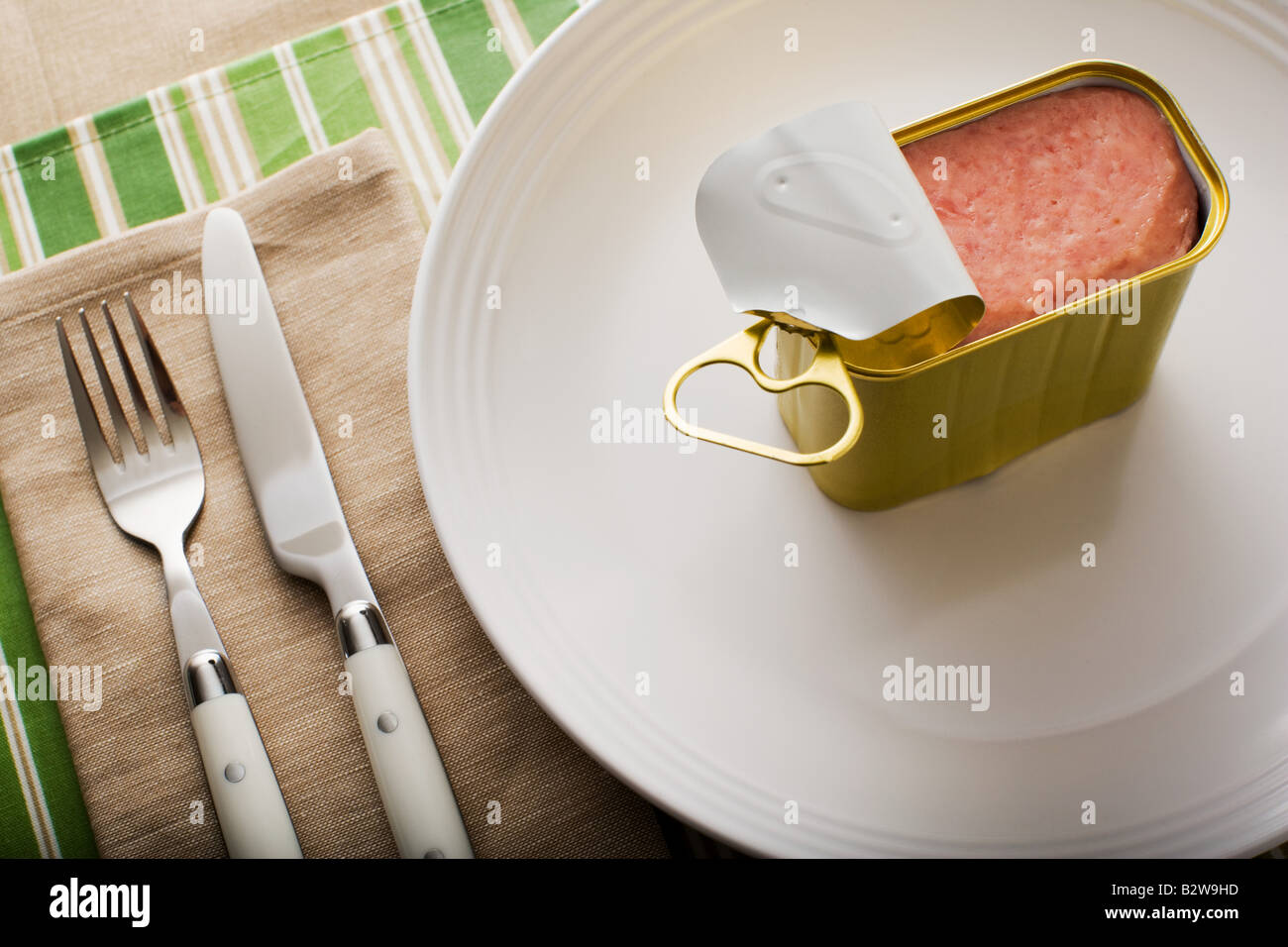 A can of ham on a plate Stock Photo