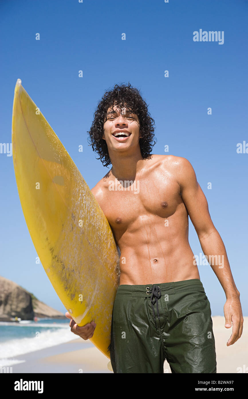 Portrait of a teenage boy with a surfboard Stock Photo - Alamy