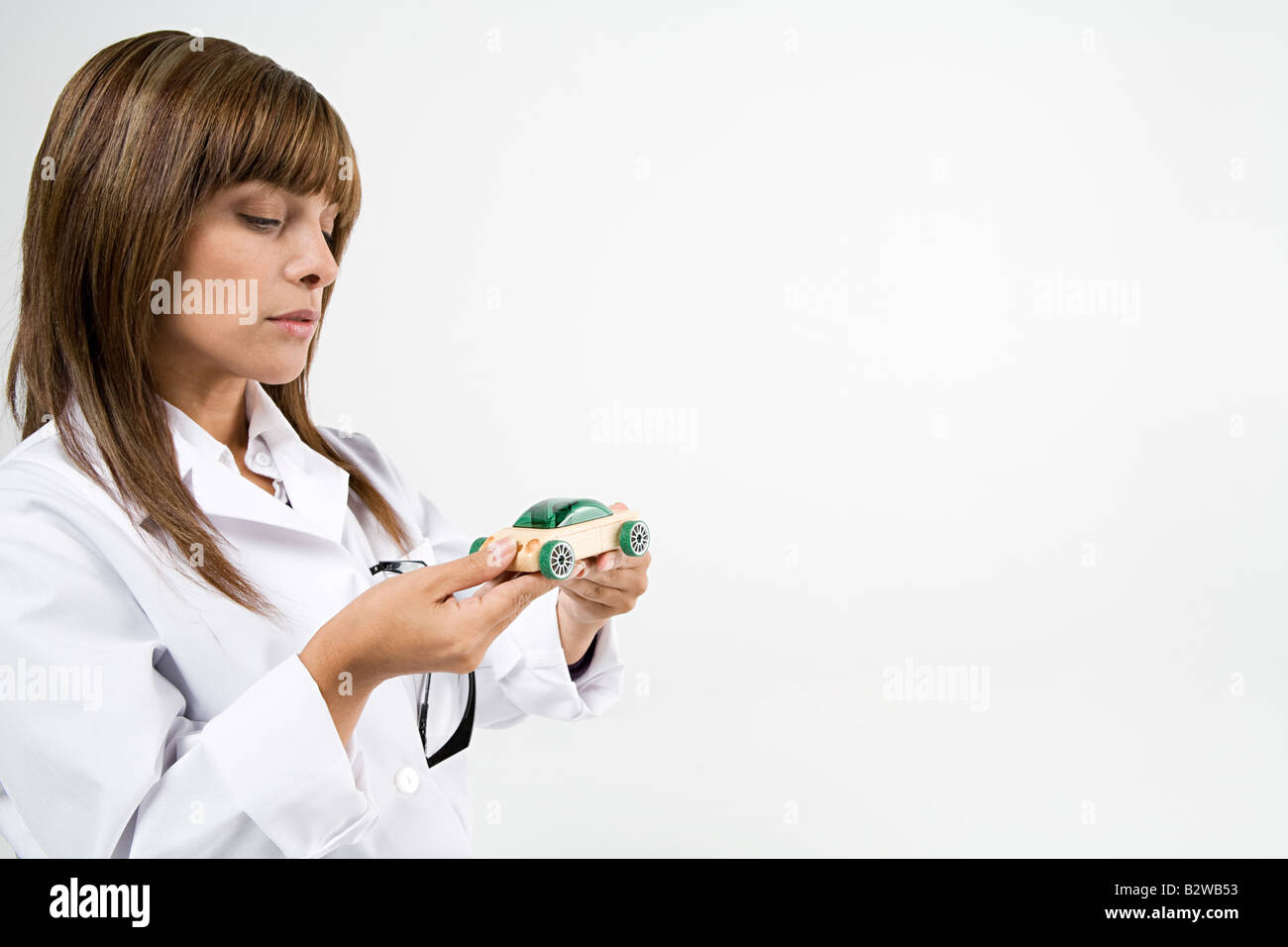Scientist holding toy car Stock Photo