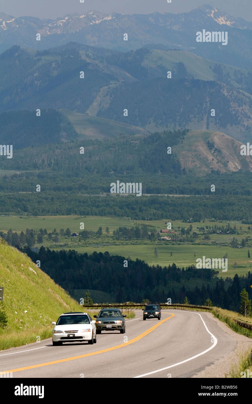 Vehicles travel over the high mountain Teton Pass on Wyoming Highway 22 near the state border of