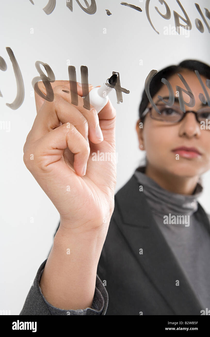 Scientist writing formula Stock Photo