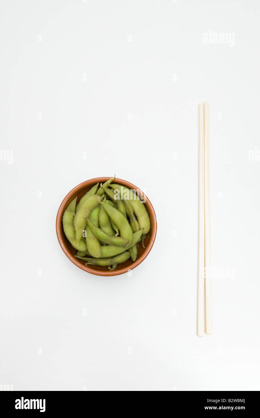 Edamame in a dish and chopsticks Stock Photo Alamy