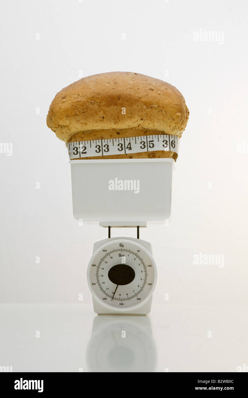 A loaf of bread on weight scales Stock Photo Alamy