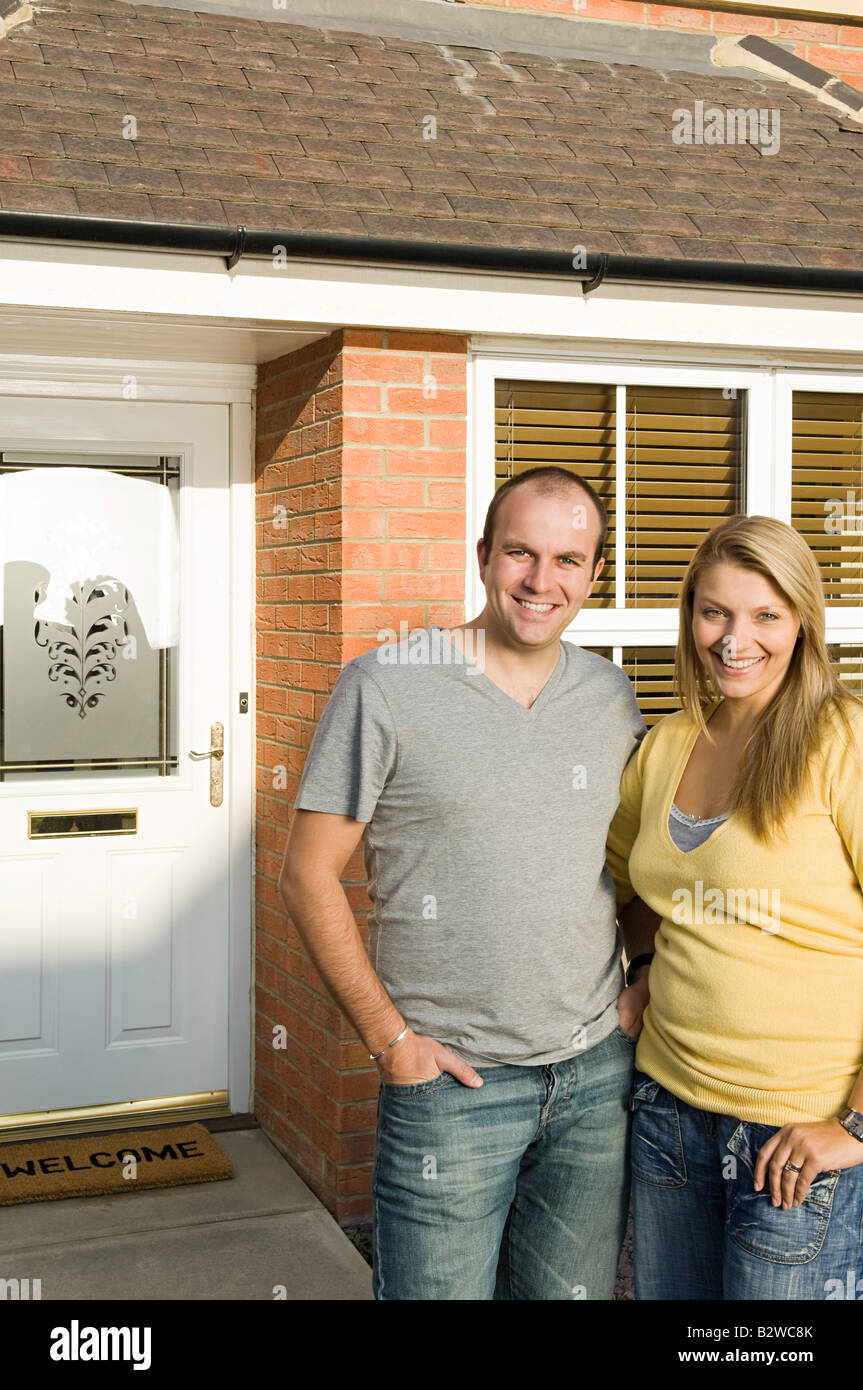 Couple outside house Stock Photo - Alamy