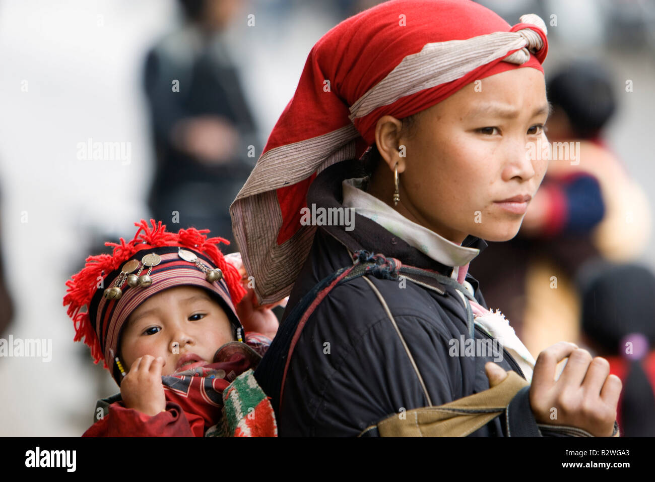 Red Dzao woman with baby on back in sling hilltribe Sapa Vietnam Stock Photo