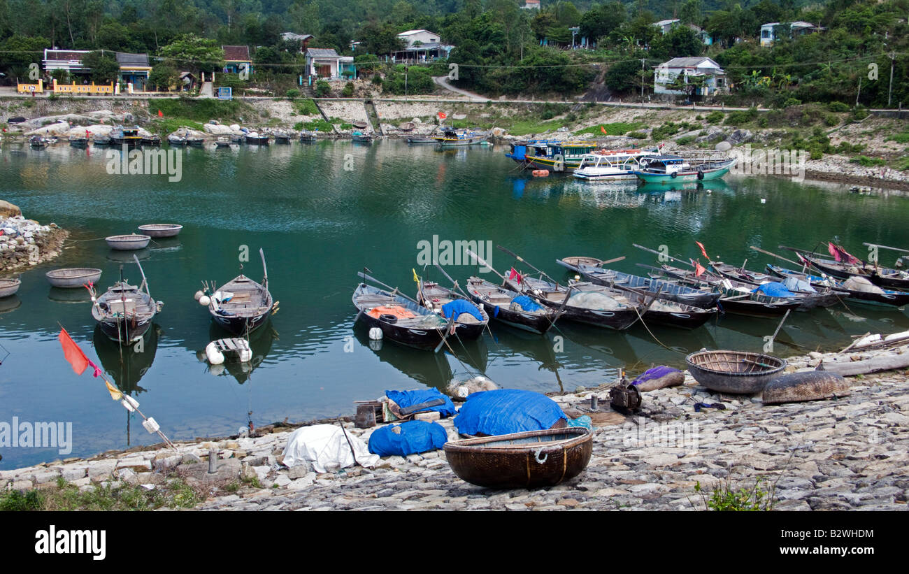Woven coracles and traditional wooden boats harbor Cham Island off historic Hoi An Vietnam Stock Photo