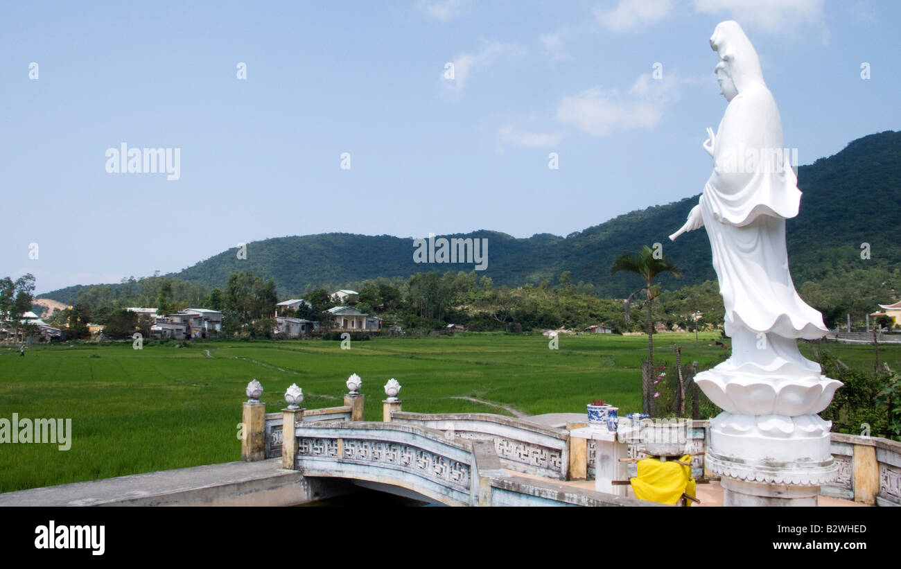 White Lady Buddha statue overlooks rice paddies Cham Island off historic Hoi An Vietnam Stock Photo