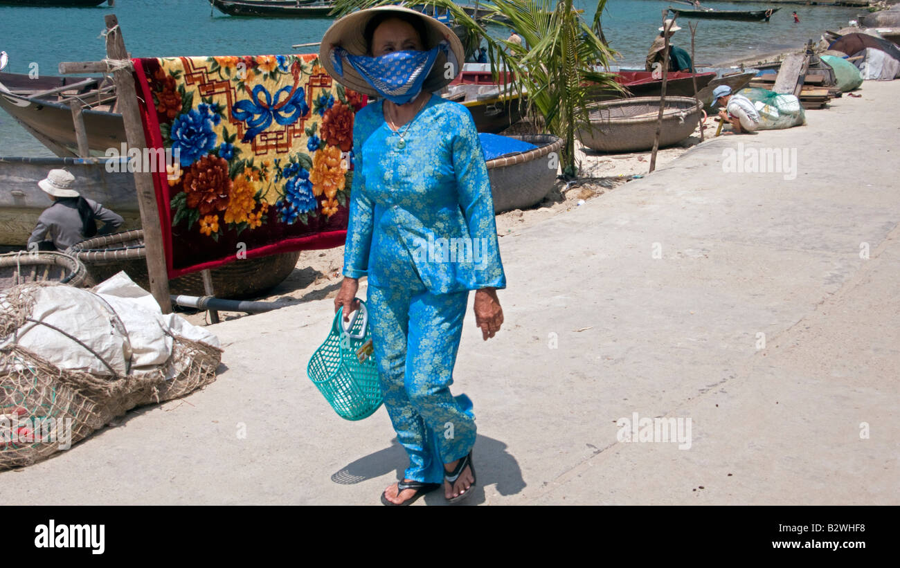 Conical hat woman traditional costume walks Cham Island off historic Hoi An Vietnam Stock Photo