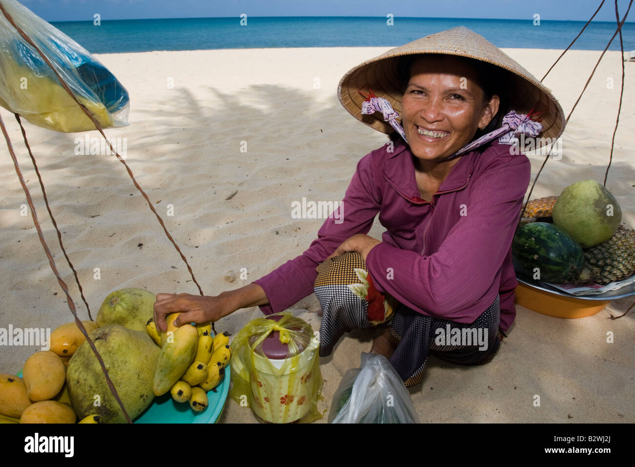 Conical hat woman tropical  fruit vendor Long Beach Phu Quoc Island Vietnam Stock Photo