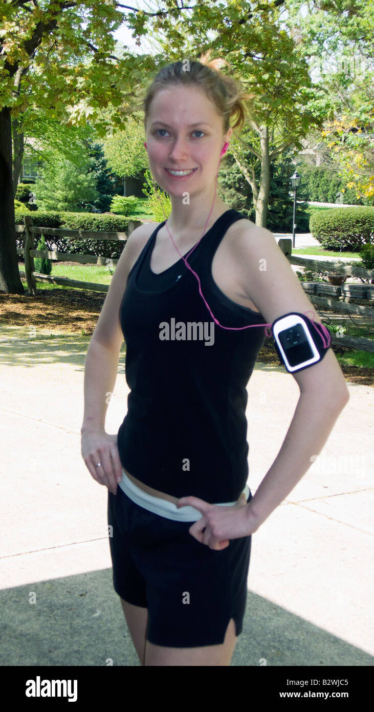 Young woman jogger with ipod music armband Illinois USA Stock Photo