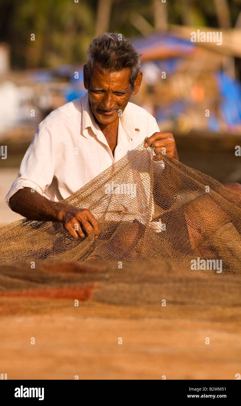 Fishermen repairing nets, Palolem Beach, Goa, India, Asia Stock Photo