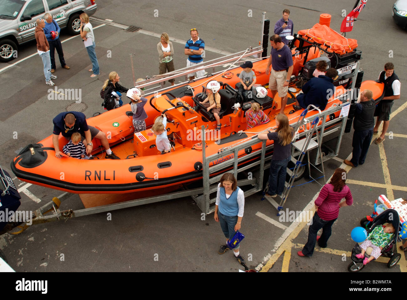 RNLI Open Day at Lymington Hampshire Children play on a lifeboat Stock