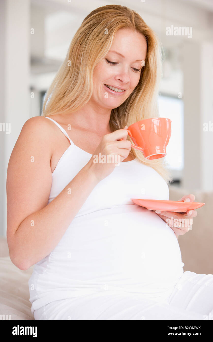 Pregnant woman with cup of tea smiling Stock Photo Alamy