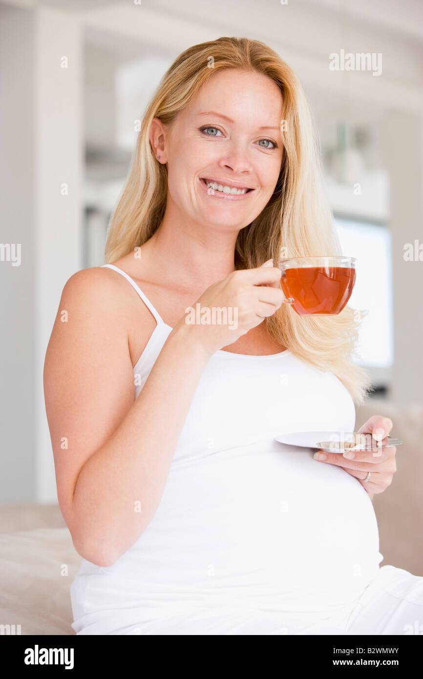 Pregnant woman with cup of tea smiling Stock Photo Alamy