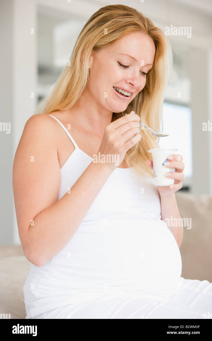Pregnant woman with yogurt smiling Stock Photo Alamy
