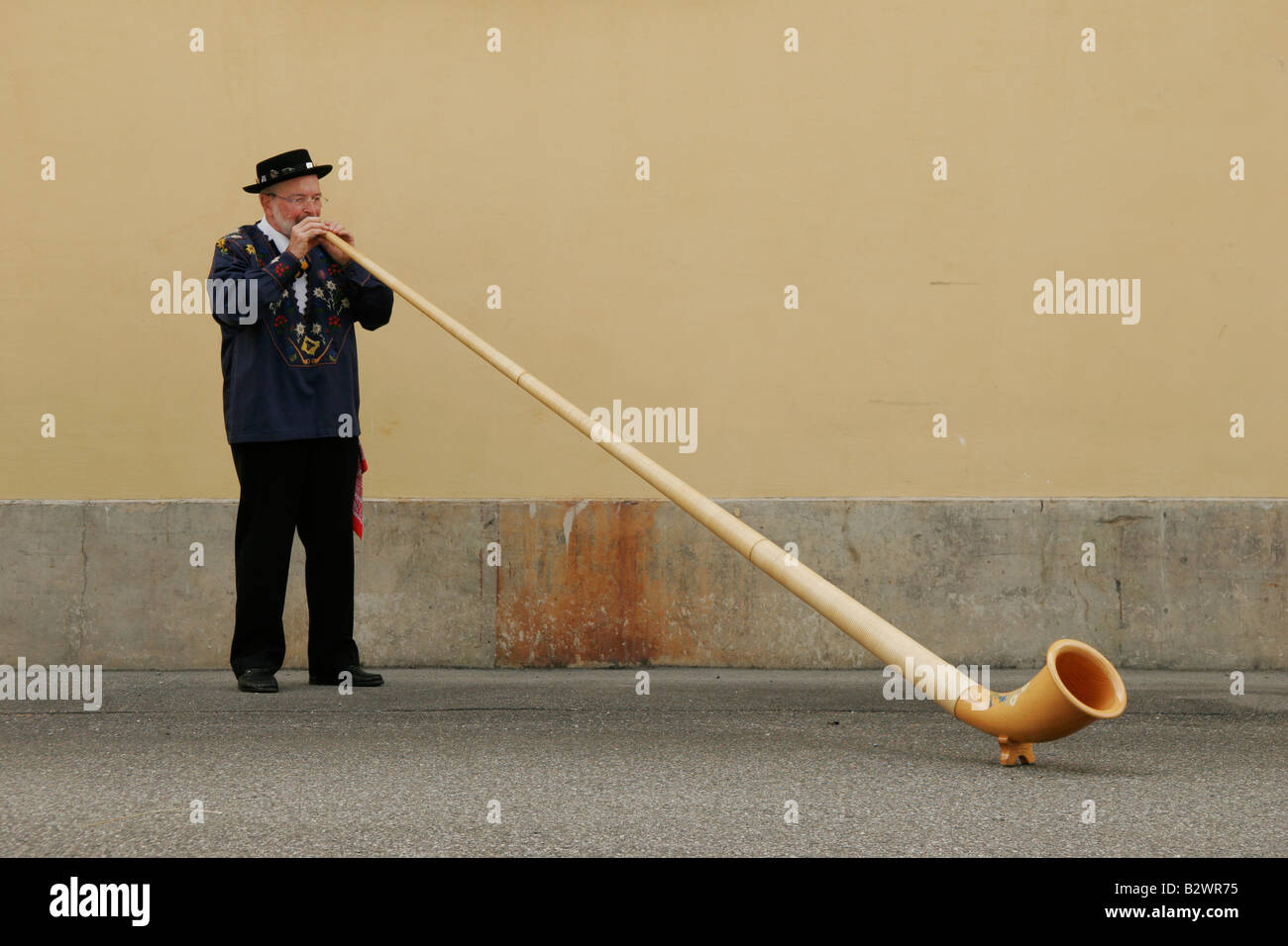 Alphorn player practices in traditional costume during Jodlerfest in Malters, near Lucerne, Central Switzerland Stock Photo