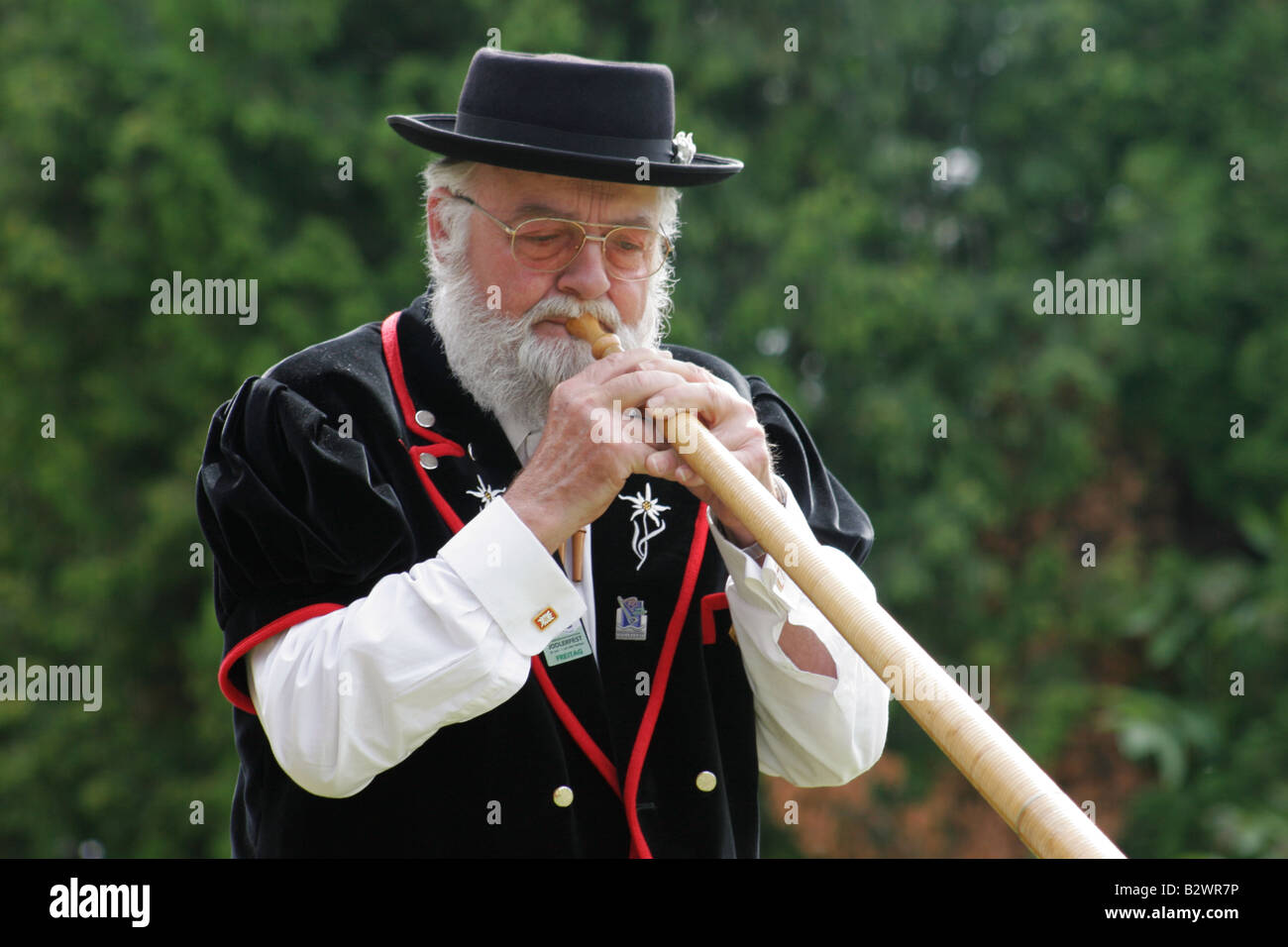 Alphorn player in traditional costume during Jodlerfest in Malters, near Lucerne, Central Switzerland Stock Photo