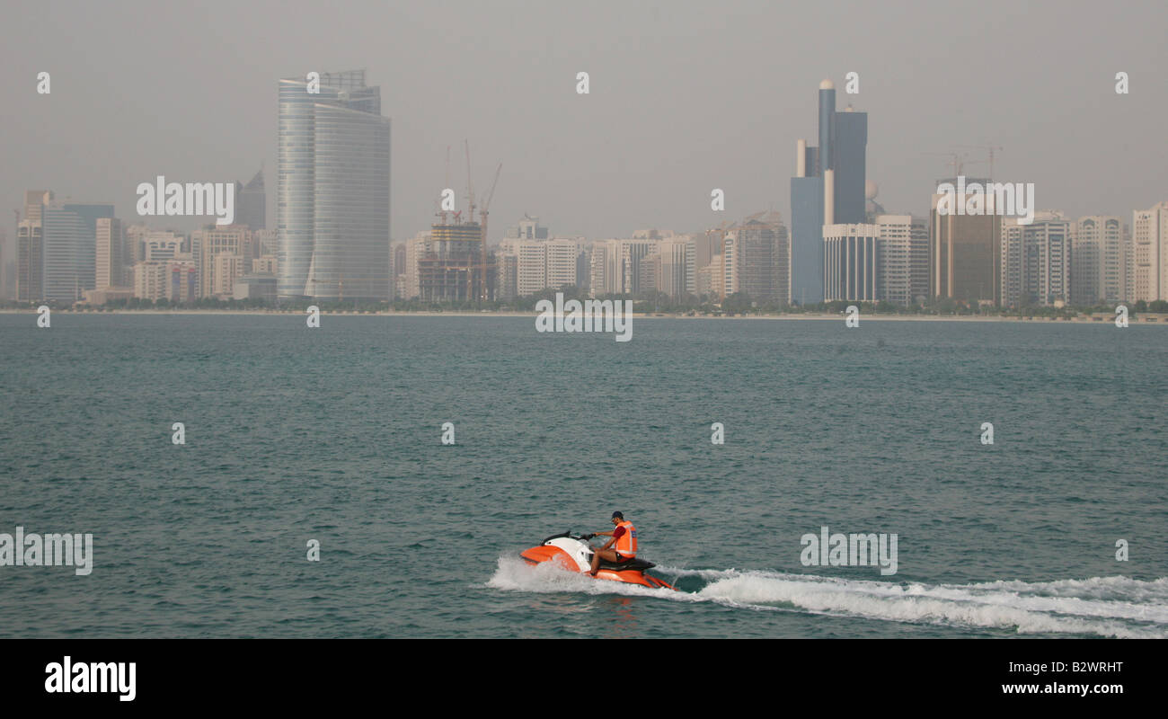 Abu Dhabi Marine Police petrol the waters as Jet skiers perform stunts in the Arabian sea along the corniche in Abu Dhabi Stock Photo