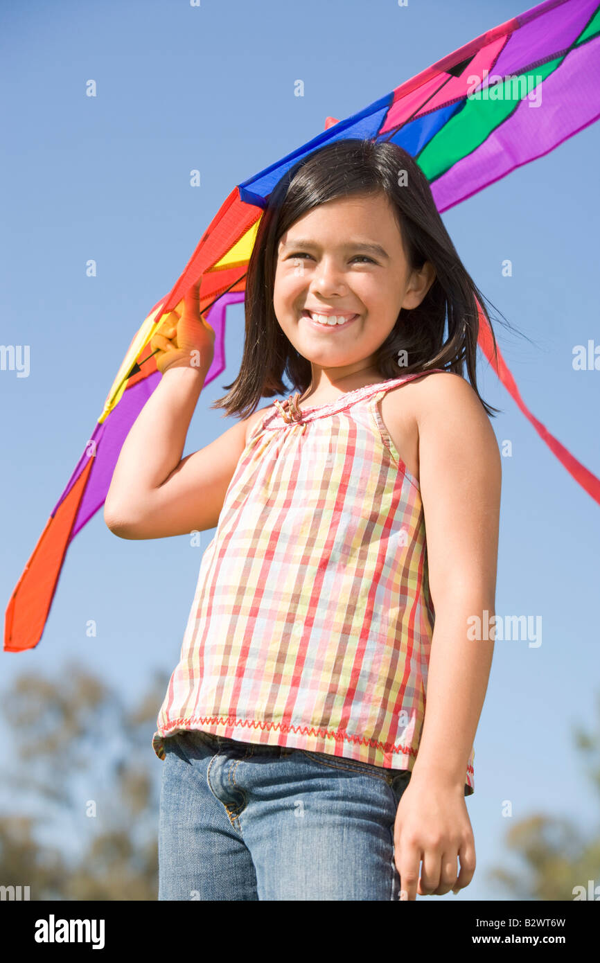 Young girl with kite outdoors smiling Stock Photo Alamy