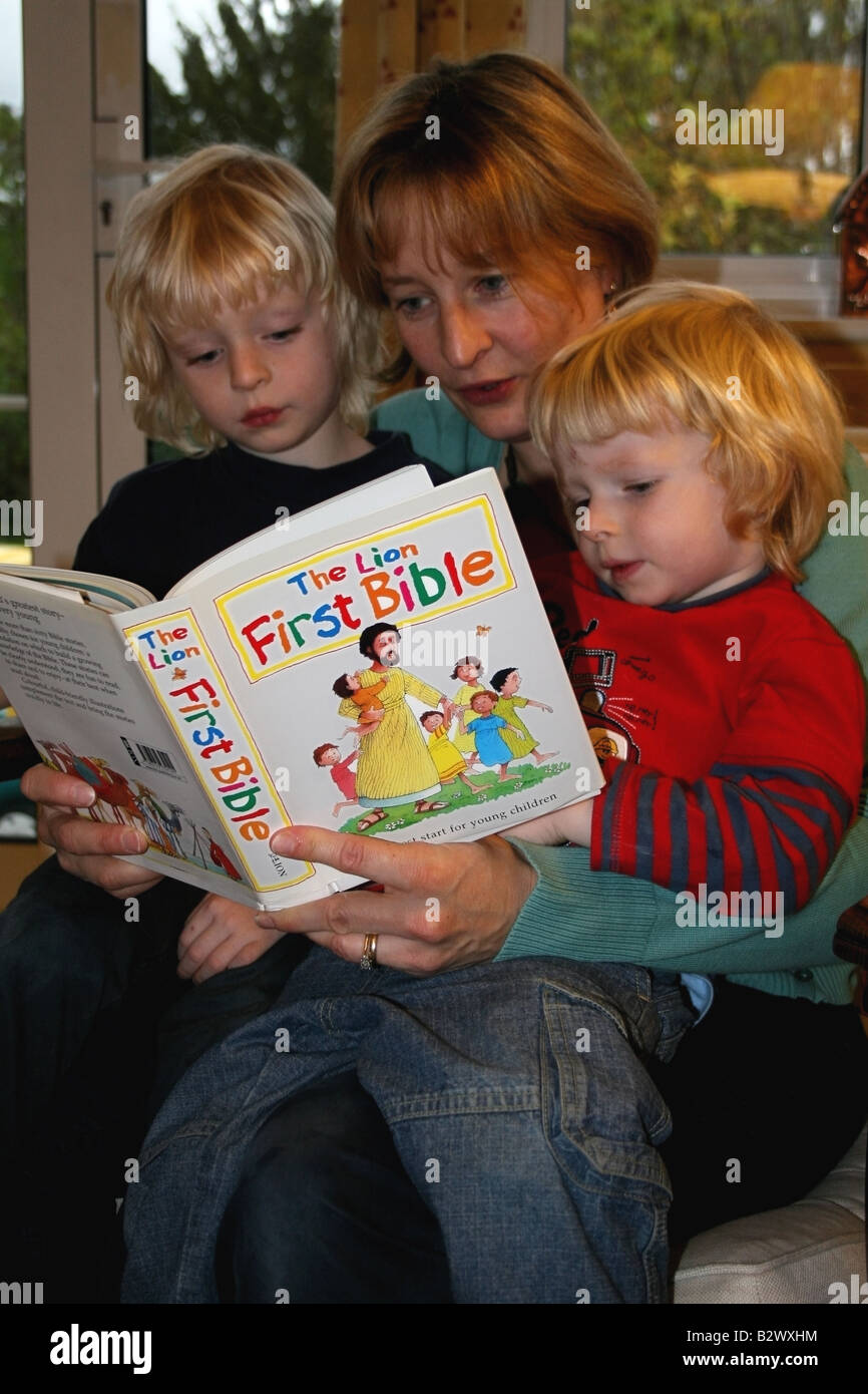 Christian Mother reads bible to her children, England Stock Photo - Alamy