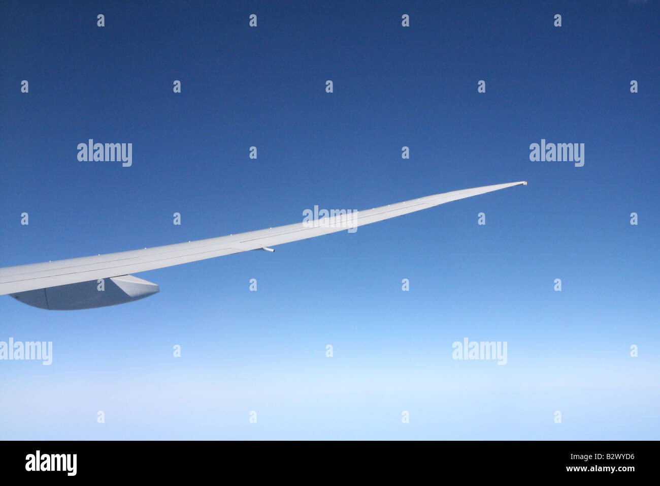 Blue skies behind the wingtip of an aeroplane Stock Photo