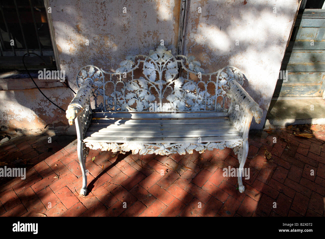WHITE PAINTED IRON BENCH IN THE HISTORIC DISTRICT OF SAVANNAH GEORGIA USA Stock Photo