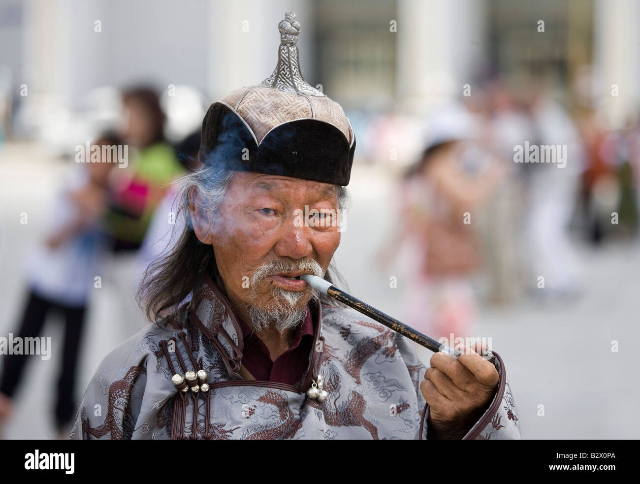 Sukhbaatar Square in the centre of Ulaanbaatar Old man smoking opium pipe Stock Photo